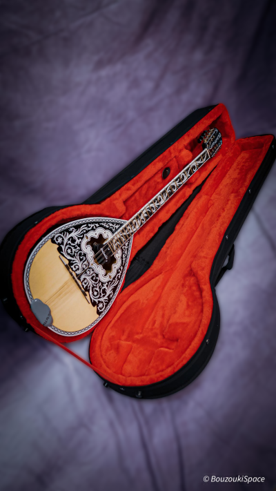 Greek bouzouki inside a hard polyfoam case with red plush lining